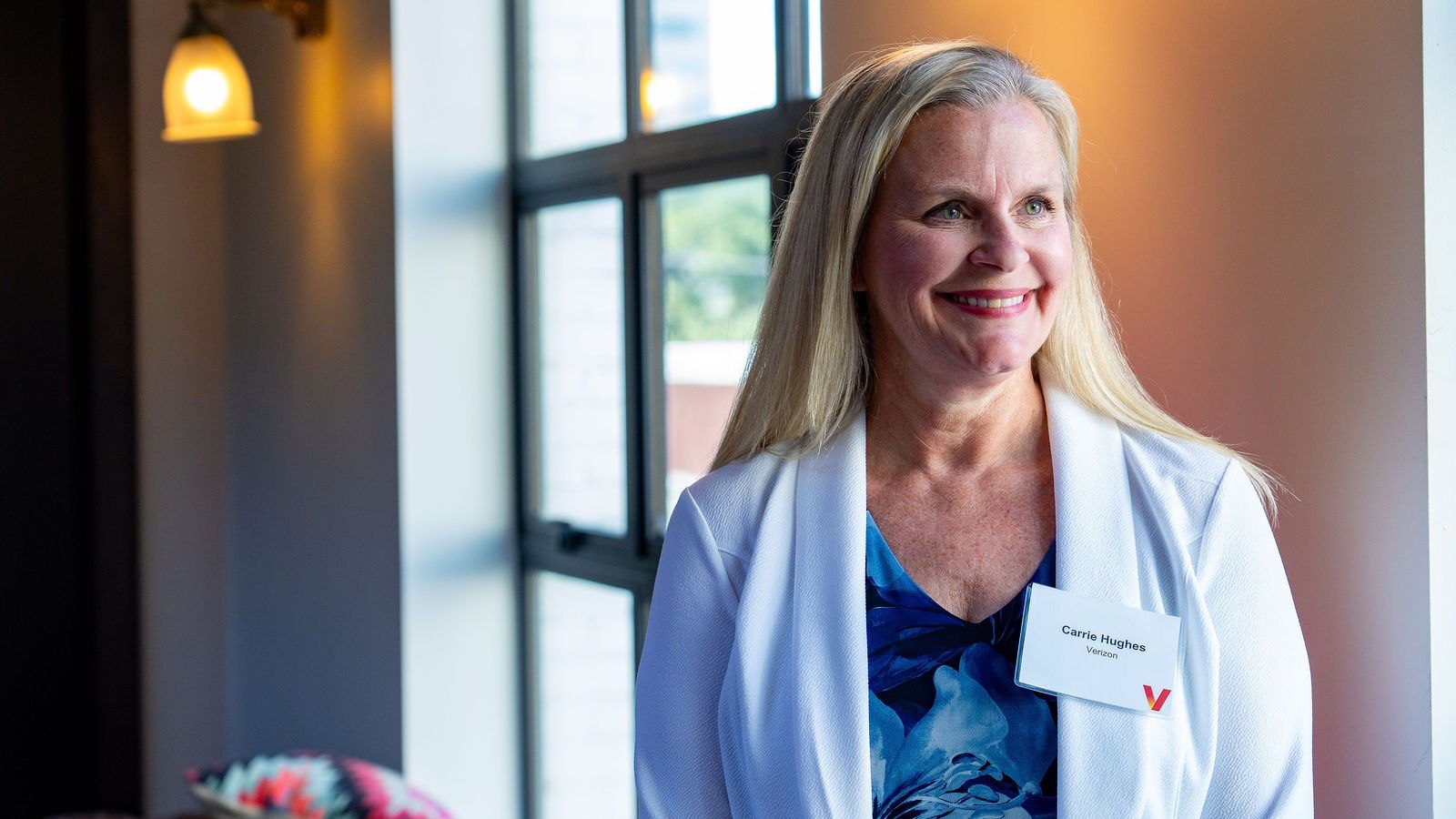 Guest portrait captured beside a sunlit venue window